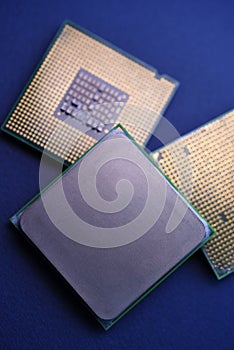 The shiny cover of the computer processor. Multiple processors on a blue background. Computer details