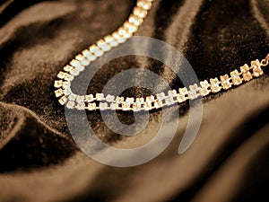 Shiny diamond jewelry necklace on black satin background for valentines day.