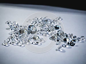 Shiny diamonds stones laying on white table