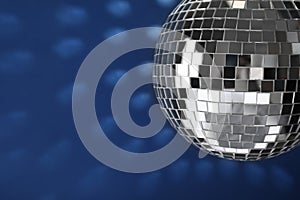 Shiny disco ball on blue background, closeup. Space for text