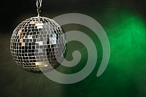 Shiny disco ball on dark background. Space for text