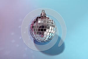 Shiny disco ball on light blue background, above view