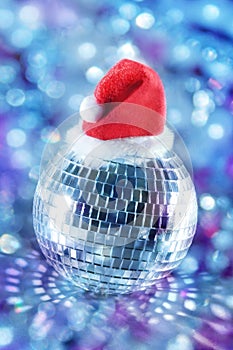 Shiny disco ball in santa hat