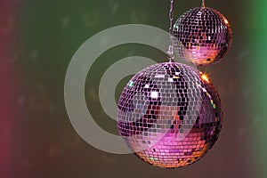Shiny disco balls on color background, space for text