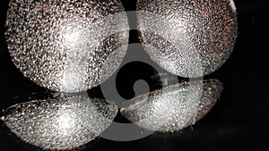 shiny ear rings on a reflective surface
