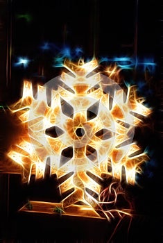 Shiny electric christmas snow flake symbol, on dark nocturnal background.