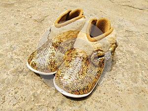 Shiny, furry, golden baby girls shoes