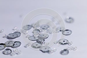 Shiny glass beads on white background. Shallow depth of field.