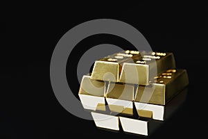 Shiny gold bars on black. Space for text