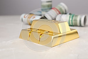 Shiny gold bars and dollar rolls