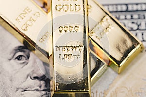 Shiny gold bullions ingot stack on america US dollar banknote mo
