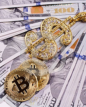 Shiny Gold Dollar Sign Necklace and Physical Bitcoin on a United States Dollar Bills