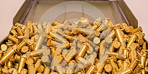 Shiny gold plated bullets inside an open container