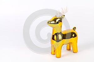 Shiny gold reindeer ornament with copy space, on white