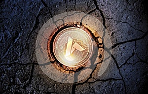 Shiny golden ARDOR cryptocurrency coin on dry earth dessert background mining photo