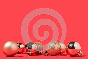 Shiny golden Christmas decoration balls on red background. Christmas or New year concept