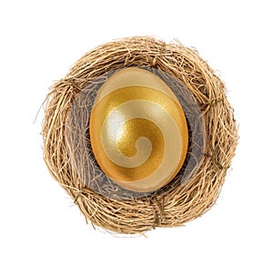 Shiny golden egg in nest on white background, top view