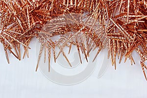 Shiny golden tinsel for Christmas tree decoration isolated on white. Christmas background for textan white background. Multi-color