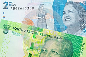 A shiny, green 10 rand bill from South Africa paired with a blue two thousand bank note from Colombia.