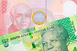 A shiny, green 10 rand bill from South Africa paired with a colorful red one thousand colones bank note from Costa Rica.