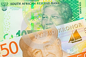 A shiny, green 10 rand bill from South Africa paired with a gray and orange fifty kronor note from Sweden.