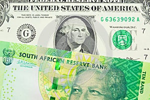 A shiny, green 10 rand bill from South Africa paired with a green one dollar bill from the United States.