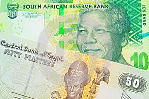 A shiny, green 10 rand bill from South Africa paired with a green and yellow fifty piastre note from Egypt.