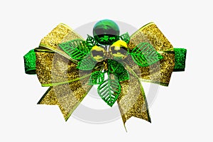 Shiny green and gold Christmas bow and ball isolated on white background with copy space. Ribbon for gift or present concept.