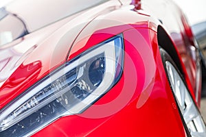 Shiny headlights on a red sports car