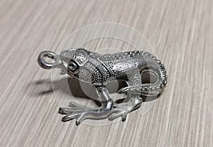 shiny lizard toy pendant keychain on the table