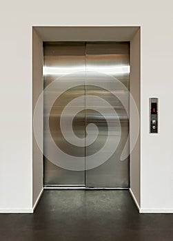 Shiny metal doors of a modern passenger elevator