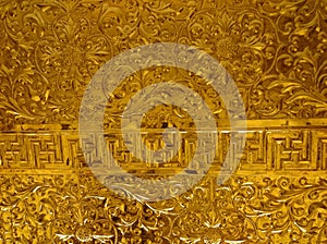 Shiny metal relief - probably gold - in buddhist temple of Ninh