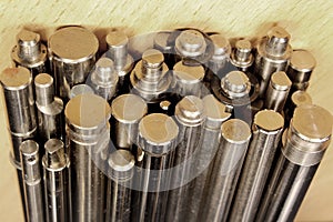 Shiny metal round bars and rods on steel background