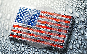 Shiny metal US American flag covered in water drops. Patriotic USA flag symbolizing the United States of America for 4th of July,