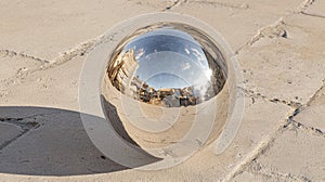 A shiny, metallic sphere with a reflective surface.
