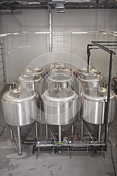 Shiny microbrewery beer tanks at beer factory