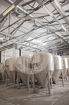 Shiny microbrewery beer tanks at beer factory