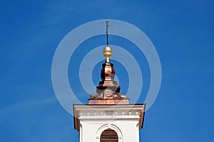shiny new red copper plated steep church tower exterior roof elevation in closeup view in Veszprem, Hungary
