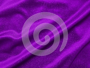 Shiny purple crumpled fabric texture. Elegant wavy cloth background
