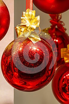 Shiny red Christmas bauble with gold glitter