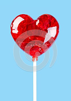 Shiny red lollipop in the shape of a heart for Valentine`s day