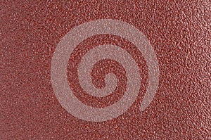 Shiny red sand paper texture background with glitters and sparkles