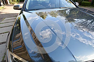 Shiny reflective car hood surface photo