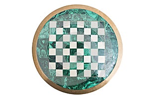 Shiny round green stone empty chess board on isolated background.