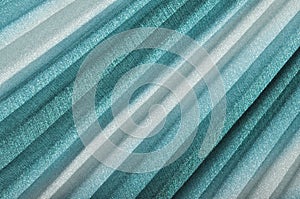 Shiny seagreen textile background, turquoise pleated cloth as creative backdrop,   blue beautiful  bright material,  turquise