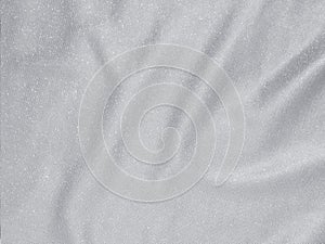 Shiny silver crumpled fabric texture background