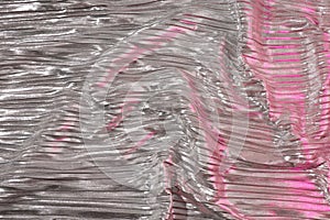 Shiny silver fabric with pink. Abstract background. Events, celebrations, Christmas, New Year. Trendy backdrop.