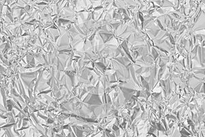 Shiny silver foil texture background, pattern of white grey wrapping paper with crumpled and wavy