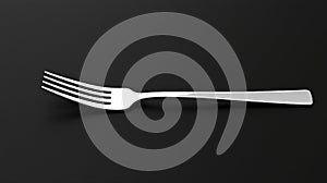 A shiny silver fork with four tines and a long handle.