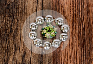 shiny silver metallic bracelet with beautiful small broach in the middle isolated on old vintage hardwood